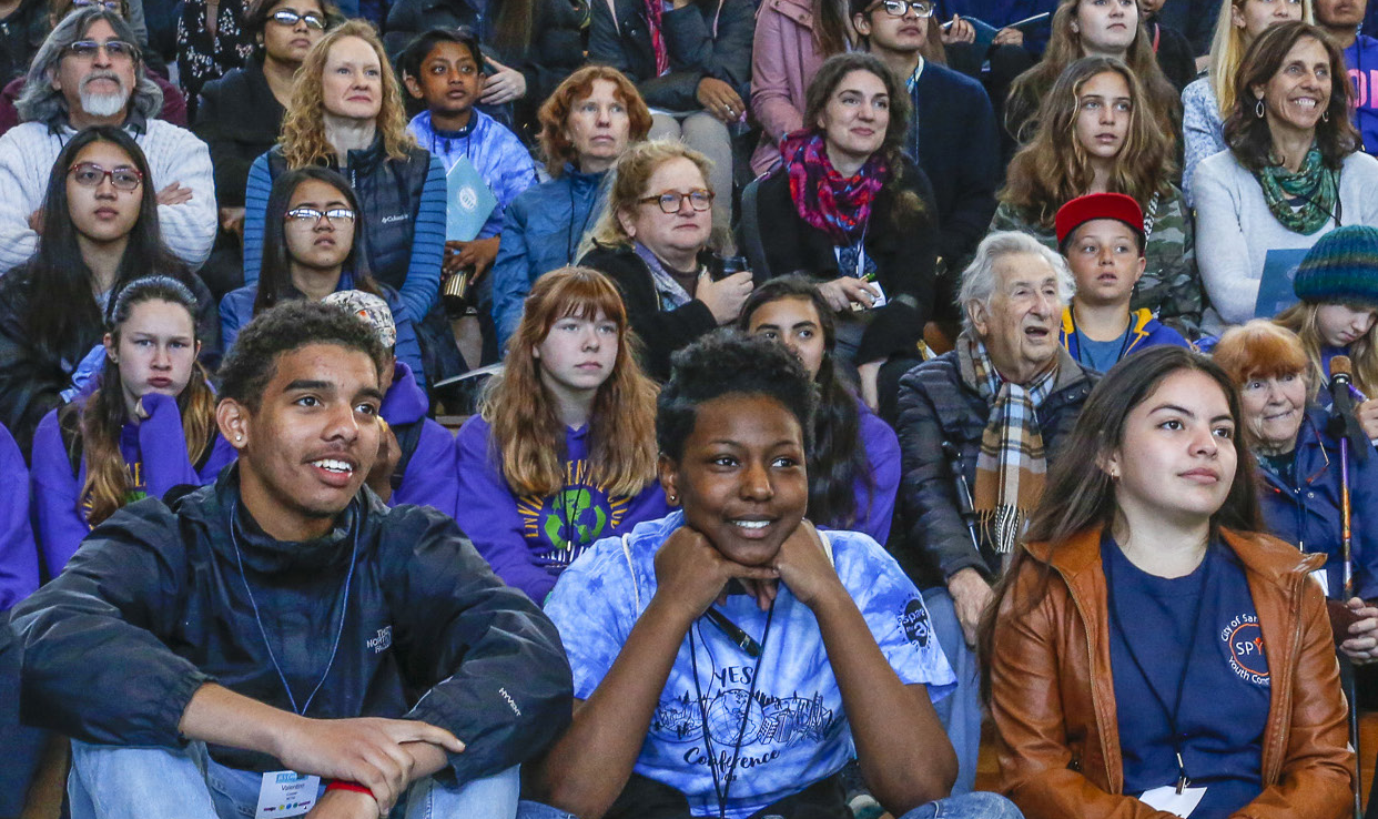 Cheerful attendees of all ages at public meeting