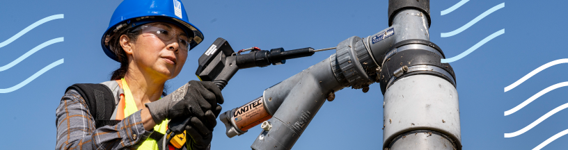 Air District woman technician testing pipe valve, with wave lines as part of design